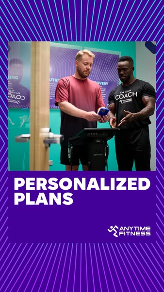 The ad features two men standing in front of a fitness kiosk discussing personalized plans with the Anytime Fitness bran