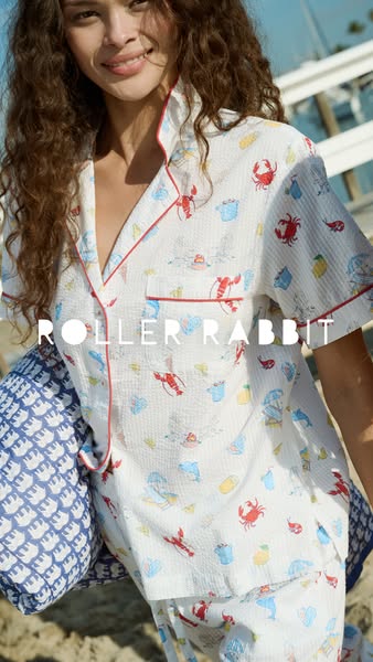 This image ad showcases Roller Rabbit pajama sets for adults. The model wears a white set with a beach-themed print, sta