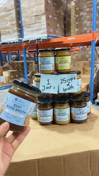 An image of bone broth jars stacked in a pyramid, with the quantity of cups of broth noted.