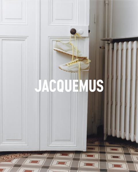 The ad showcases a pair of Jacquemus sneakers hanging from a door handle, set against a minimalistic backdrop. The brand