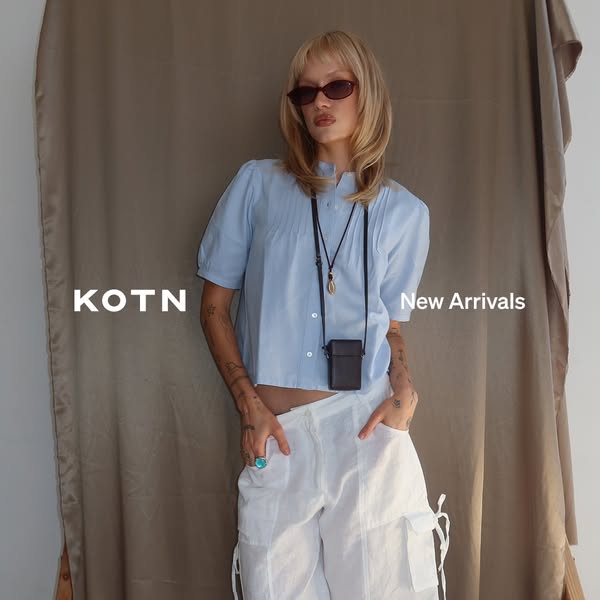 The ad features a model wearing a light blue shirt and white pants. The ad is meant to highlight new arrivals at KOTN.