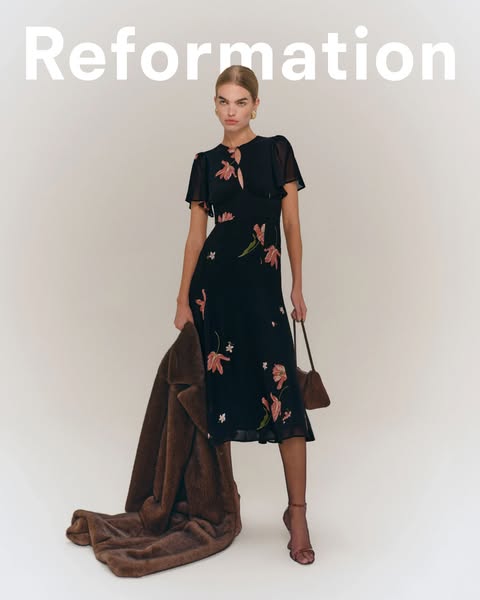 This ad showcases a Reformation dress. The ad features a model wearing the dress and holding a coat. The brand name is d