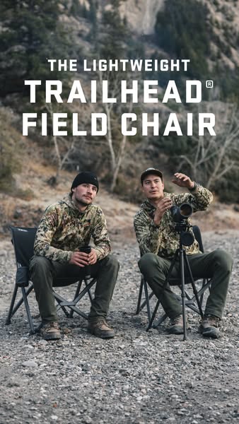 This image ad features two men sitting in the Trailhead Field Chair in front of a mountain. The ad is trying to highligh