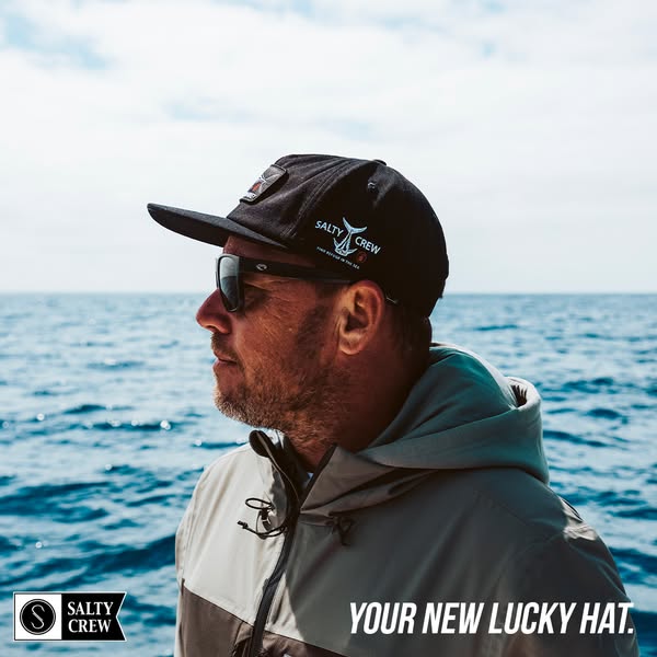 The ad features a man wearing a black Salty Crew hat and sunglasses, set against a backdrop of the ocean. The ad emphasi