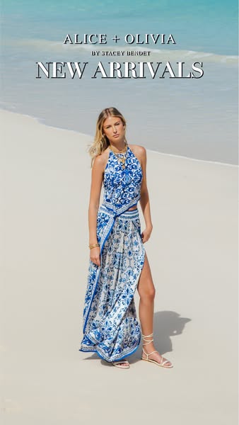This image ad features a young woman in a blue and white patterned outfit standing on a sandy beach next to crystal blue