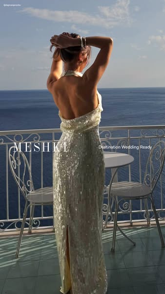 This ad showcases a woman wearing a sequined gown and looking out at a seaside view. It promotes the brand MESHKI, posit