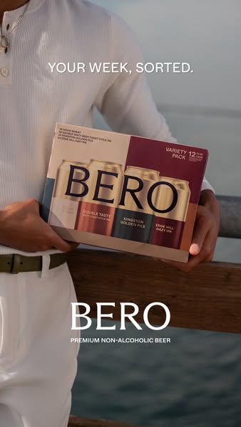 The ad features a man holding a variety pack of BERO non-alcoholic beer while standing near a body of water. The ad is t