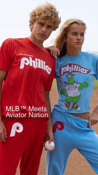 This ad features two models in matching Philadelphia Phillies-branded sweat suits. The text reads, "MLB™️ Meets Avi