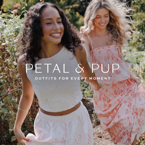 An image ad for Petal & Pup clothing showing two women smiling and walking in nature wearing matching top and skirt 