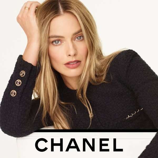 This image ad features actress Margot Robbie as the face of Chanel. The ad prominently features a black Chanel jacket an