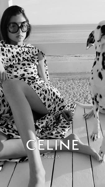 This black and white ad for Celine features a young woman in a patterned dress and large sunglasses, sitting outside wit