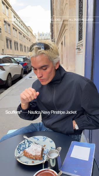 This image ad shows a person in a Nautica Navy Pinstripe Jacket who is sitting outside at a table and is about to eat a 