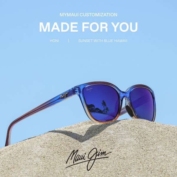 This ad showcases MyMaui customizable sunglasses by Maui Jim. Against a sunny sky, the sunglasses rest on sand, their bl