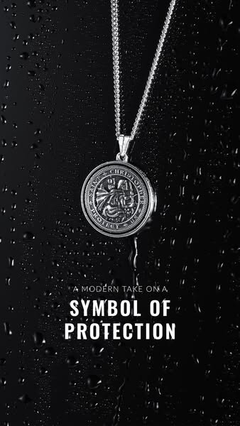 This ad features a close-up image of a silver Saint Christopher pendant necklace against a black background with water d