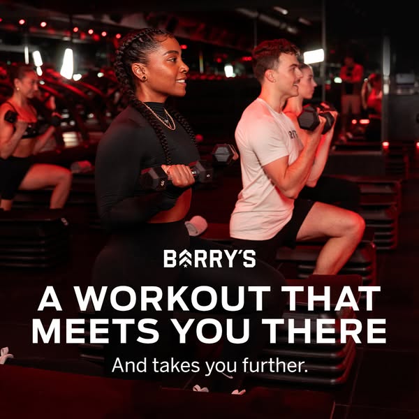 Image ad for Barry's fitness, showing participants lifting dumbbells in a Barry's fitness studio, with the text,