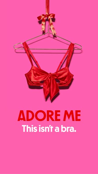 This ad features a red bra that is tied with a bow and hung on a hanger in front of a pink background. The messaging say