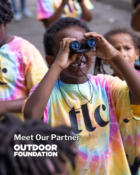 An image showing an eye-level shot of a smiling child holding binoculars up to their eyes. The image is accompanied by t