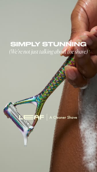 Close-up shot of a person holding the Leaf razor with shaving cream on their leg. Text emphasizes the stunning razor and