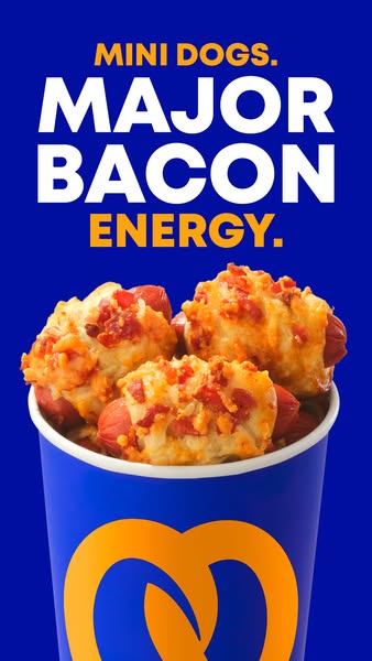 This image ad for Auntie Anne's promotes their mini dogs with major bacon energy. The ad features a close-up shot of