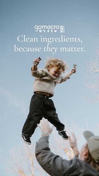 This ad for GoMacro Kids shows a child being thrown into the air by an adult. They are both holding GoMacro bars. The ad