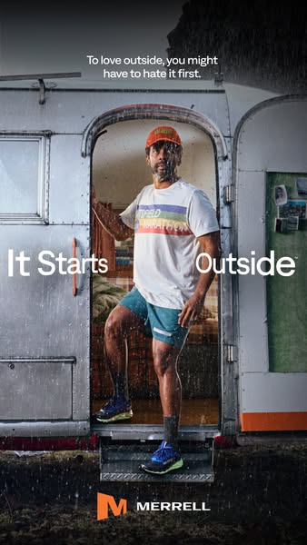 This image ad shows a man who has likely been running outside in the rain. He's walking into an airstream camper and
