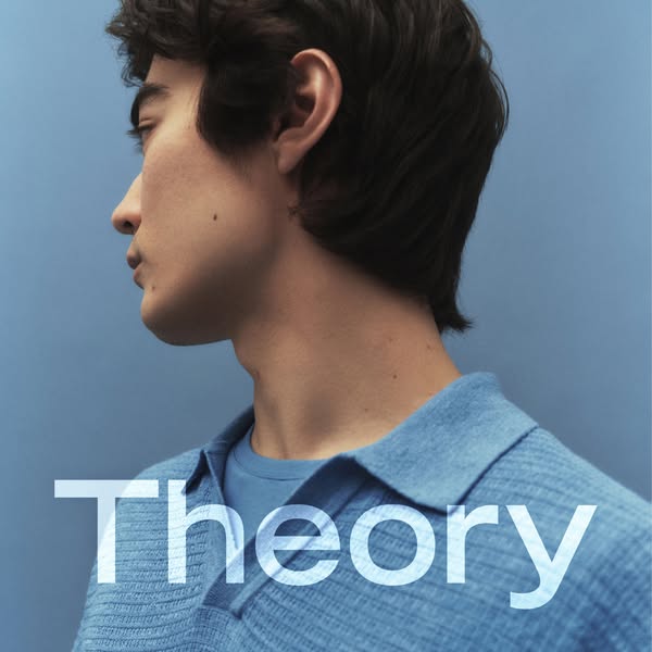 An ad for Theory clothing, featuring a close-up profile shot of a person wearing a polo shirt and T-shirt, both in light