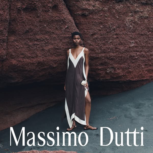 This image ad for Massimo Dutti features a woman wearing a brown maxi dress in front of a red rock formation. The ad aim
