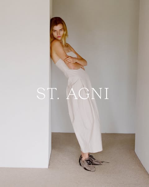 This ad for St. Agni features a model leaning against a wall, showcasing the brand's clothing line.