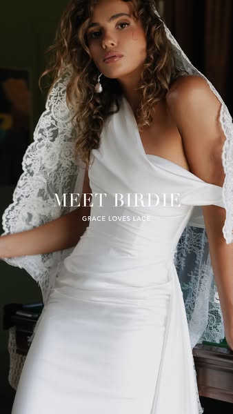 This image ad introduces Birdie by Grace Loves Lace, showcasing a model in a white wedding dress with lace details, aime