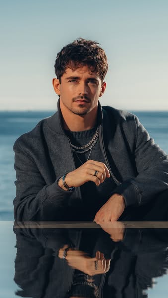 This ad features a stylish man wearing various jewelry pieces, including necklaces, a bracelet, and a ring, presented in