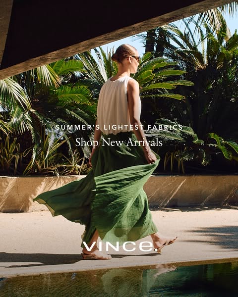 This image ad showcases a woman walking near water in a green skirt, white top, and heeled sandals to promote new arriva