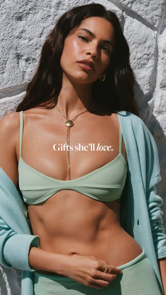 This image ad features a woman wearing a bikini top and jewelry, accompanied by the text "Gifts she'll love,&qu
