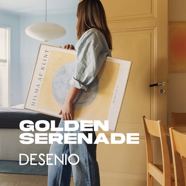 This is a photo ad featuring the brand Desenio. A person is shown carrying an art print that is framed and ready for han