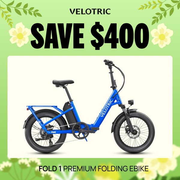 This ad features a bright blue VELOTRIC Fold 1 Premium Folding Ebike against a soft green and white floral background, h