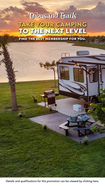 This ad features a serene lakeside camping scene at sunset, highlighting the benefits of a Thousand Trails membership. T