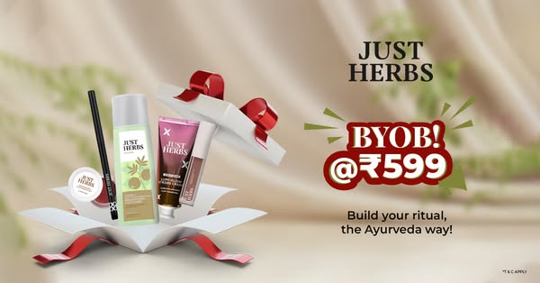 An image ad for Just Herbs features a curated selection of beauty products arranged in an open gift box with a call to a