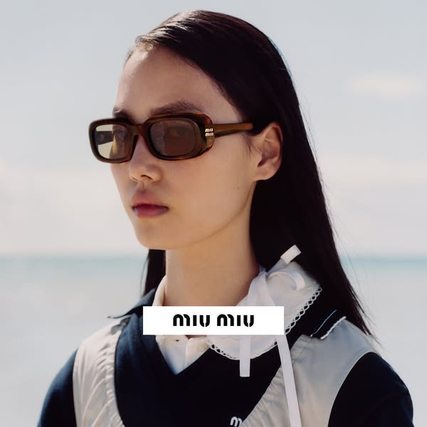 This ad features a young woman wearing Miu Miu sunglasses while standing in front of a body of water. The brand's lo