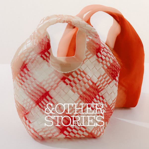 An image of two & Other Stories purses, one in front that is plastic-woven and one in the back that is silky.