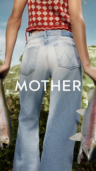 This ad for Mother Denim features an image of a woman from behind wearing light-wash jeans, holding a fish in each hand 