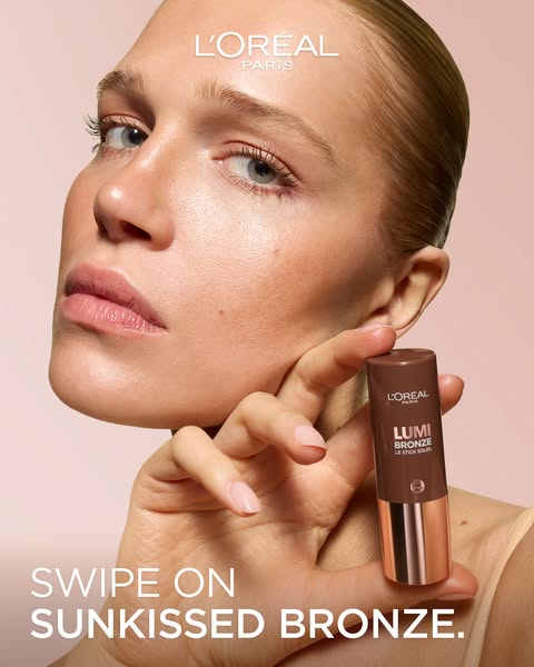 An ad for L'Oréal Lumi Bronze bronzer stick features a light-skinned woman holding the product. The ad focuses on ac