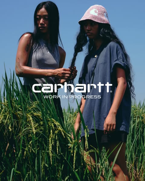 This Carhartt image ad showcases two women in a field wearing Carhartt apparel. The ad is set against a natural backdrop