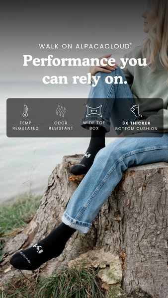 This ad promotes AlpacaCloud socks. It features a person sitting on a tree stump by a body of water, wearing the black s