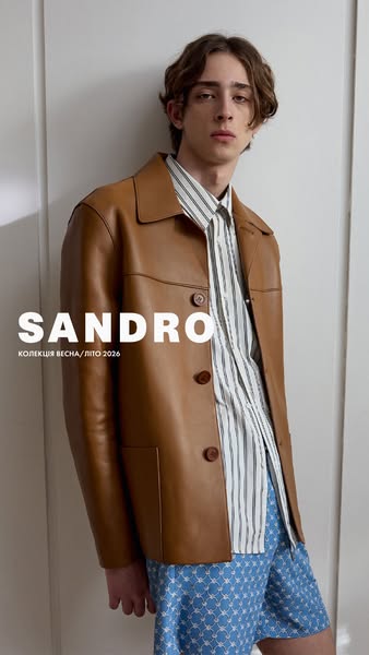 This image showcases a man in a Sandro jacket and shirt. The image features the brand name and indicates it is for the s