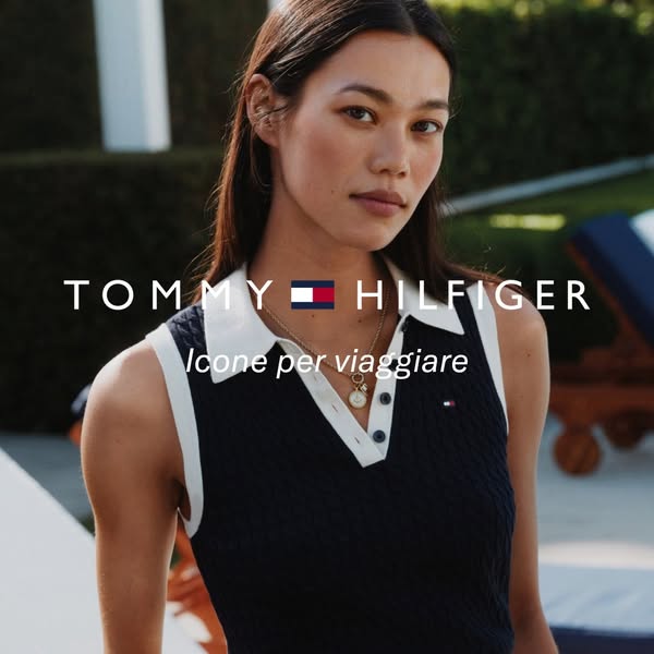 This Tommy Hilfiger ad features a woman wearing a navy blue cable knit sleeveless polo shirt, with the brand's logo 
