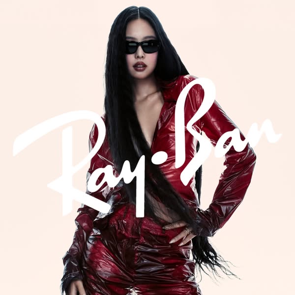 An image ad featuring Ray-Ban sunglasses worn by a model in a red vinyl outfit. The brand logo is prominently displayed 