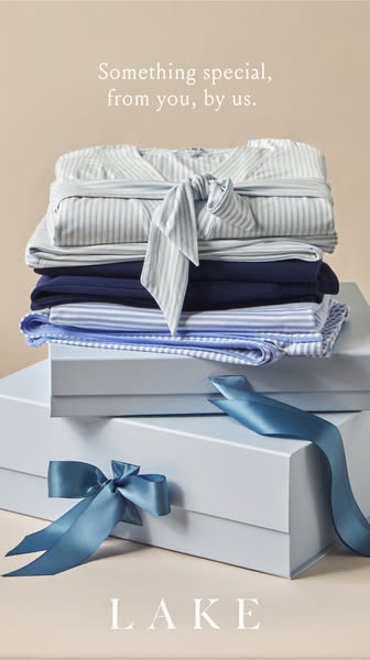 This image ad showcases a stack of LAKE clothing items wrapped with a ribbon. The items are on top of gift boxes with ri