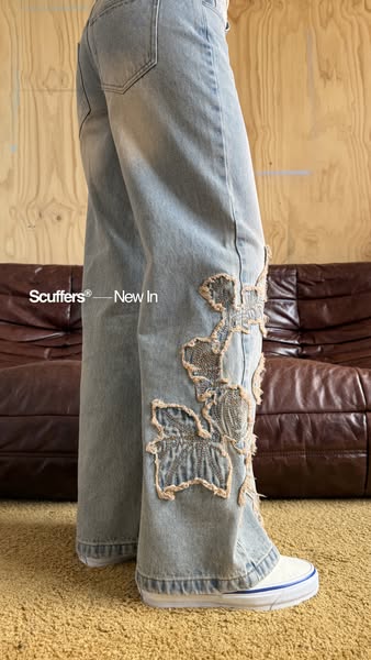 A close-up shot of a person wearing jeans, to showcase the jeans and their specific design.