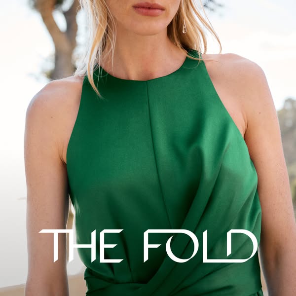 This image ad showcases a woman wearing a green dress from The Fold. The ad emphasizes the design and quality of the gar