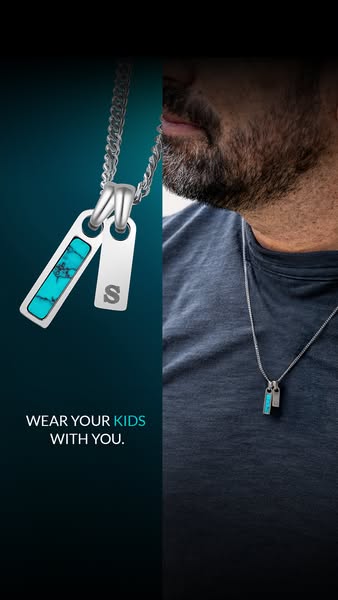 An ad for a necklace that allows you to 'wear your kids with you' and features two pendants. One is turquoise an
