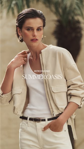 Image ad showcasing the brand's Summer Oasis collection featuring a model wearing a jacket, shirt, and jeans.